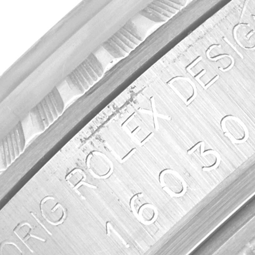 The image shows a close-up of the engraved serial number on the casing of a Rolex Vintage Collection 16030 Men's Stainless Steel Silver Dial 16030 Men's Stainless Steel Silver Dial model, including part of the fluted bezel.