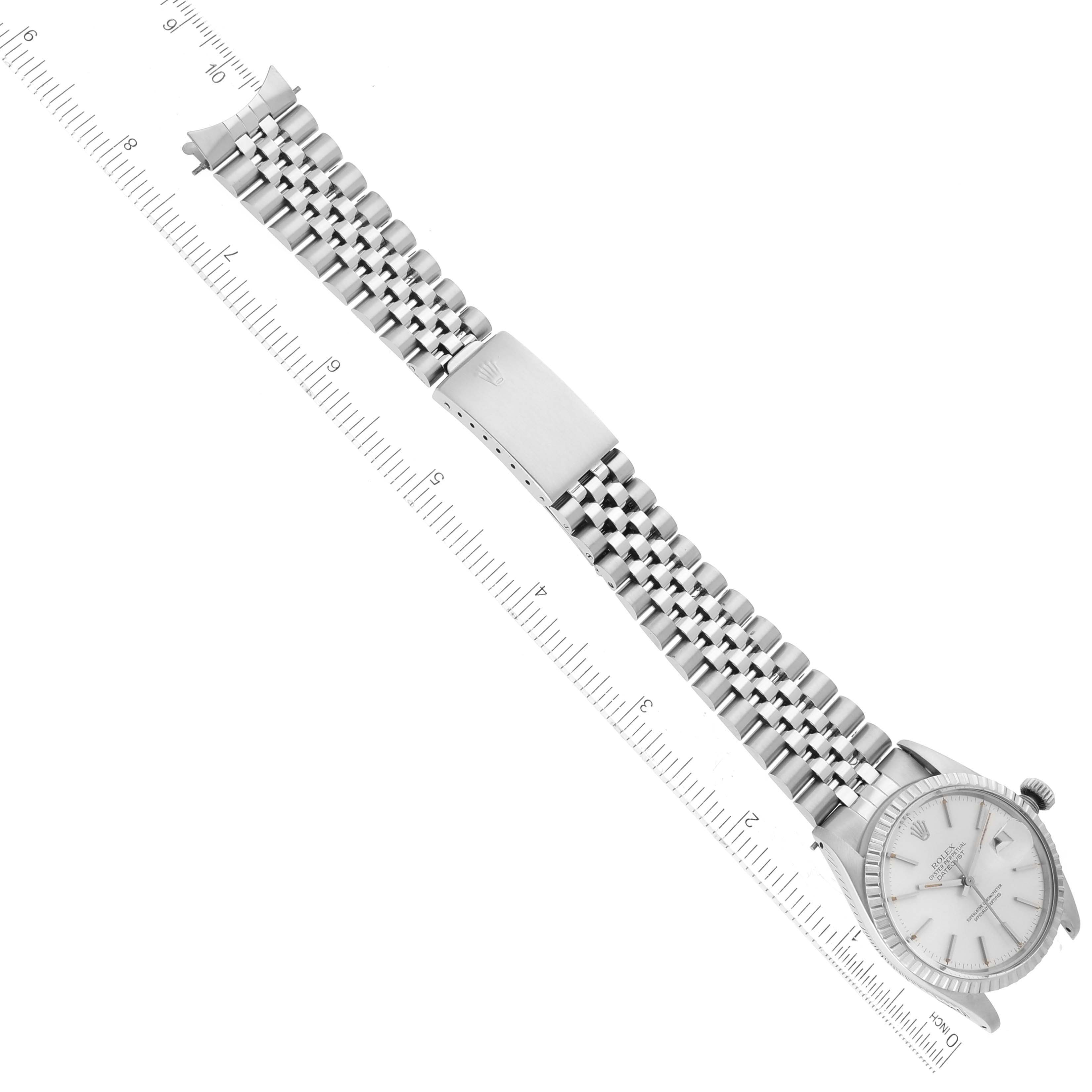 The image shows the Vintage Collection model watch by Rolex, highlighting the face, bracelet, and clasp of the watch aligned with a ruler.