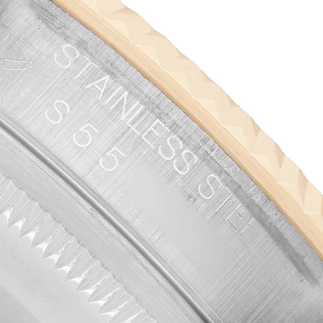 The image shows a close-up of the Rolex Datejust 16233 Men's Steel and Gold (two tone) Champagne Dial's stainless steel bezel and engraving.