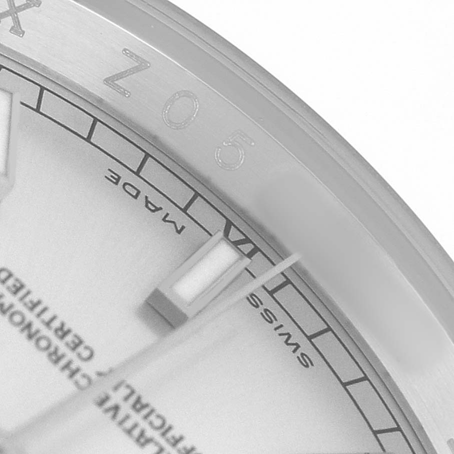 The image shows a close-up of the Rolex Datejust 116200 Men's Stainless Steel Silver Dial's dial edge, highlighting the markers, part of the bezel, and engraved details.