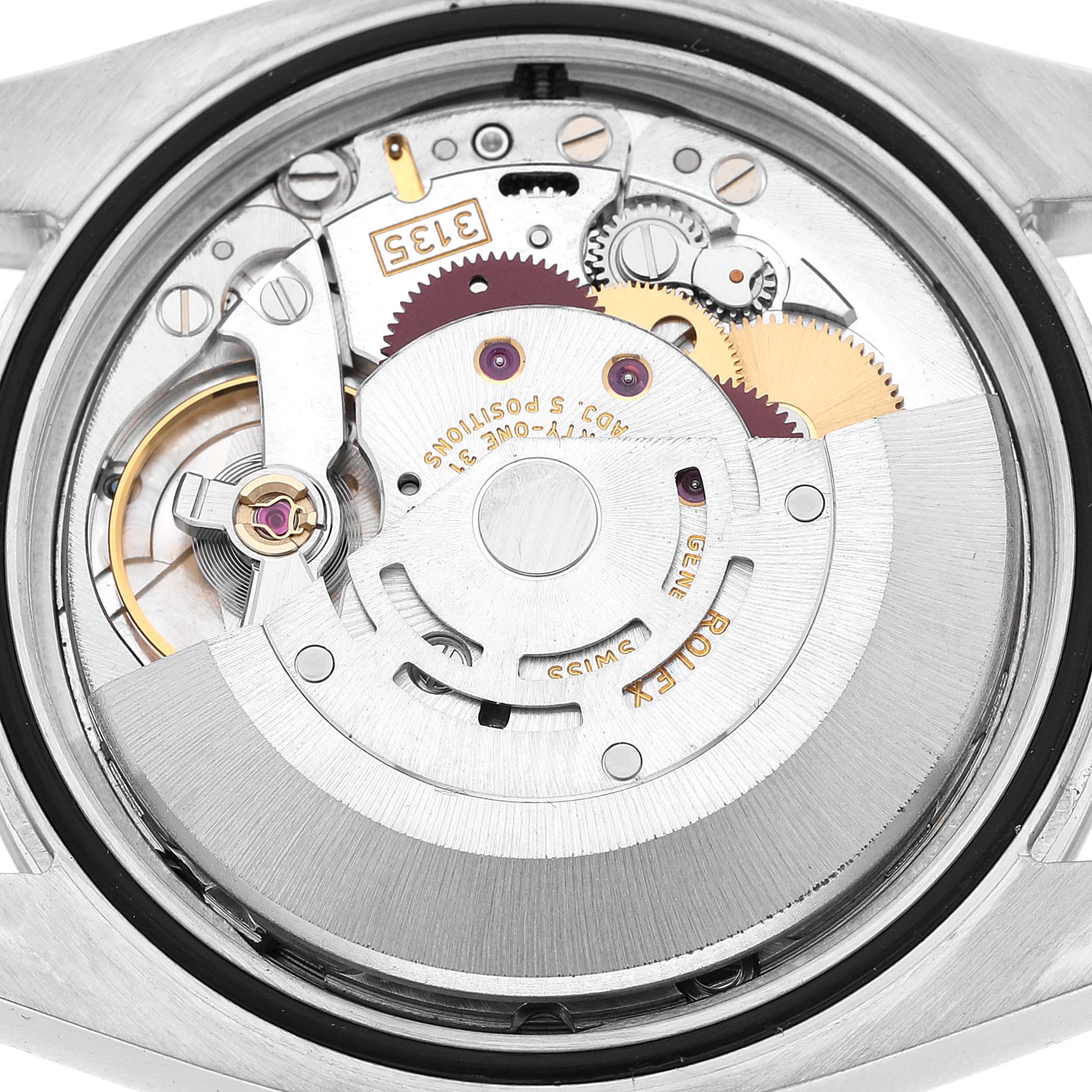 The image shows the movement of a Rolex Datejust 116200 Men's Stainless Steel Silver Dial watch from the back, highlighting gears and mechanical components.