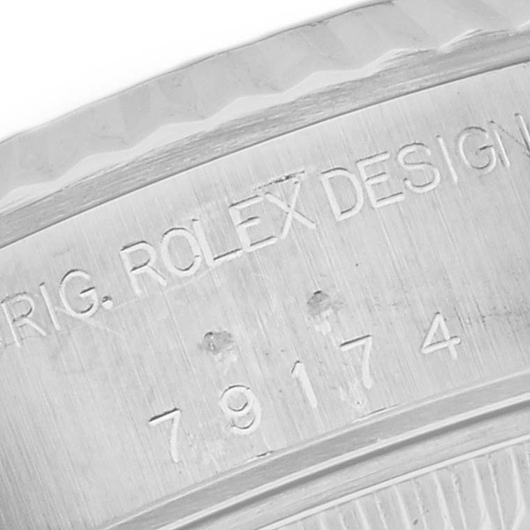 The image shows a close-up of the side of the case of a Rolex Datejust 79174 Women's Stainless Steel Mother of Pearl Dial 79174 Women's Stainless Steel Mother of Pearl Dial, highlighting the engraved serial number.
