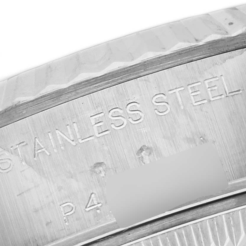 This is a close-up angle of the caseback edge on a Rolex Datejust 79174 Women's Stainless Steel Mother of Pearl Dial 79174 Women's Stainless Steel Mother of Pearl Dial, showing the "STAINLESS STEEL" engraving.