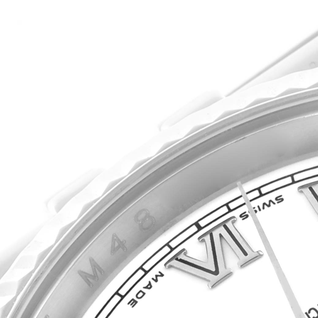 The image shows a close-up of the bezel and part of the dial with Roman numerals on a Rolex Datejust 116234 Men's Stainless Steel White Dial 116234 Men's Stainless Steel White Dial watch.