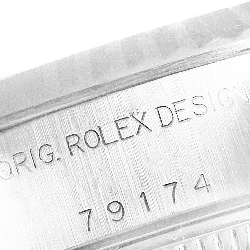 The image shows the engraved serial number and "ROLEX" text on the exterior casing of a Rolex Datejust 179174 Women's Stainless Steel Silver Dial 179174 Women's Stainless Steel Silver Dial watch.