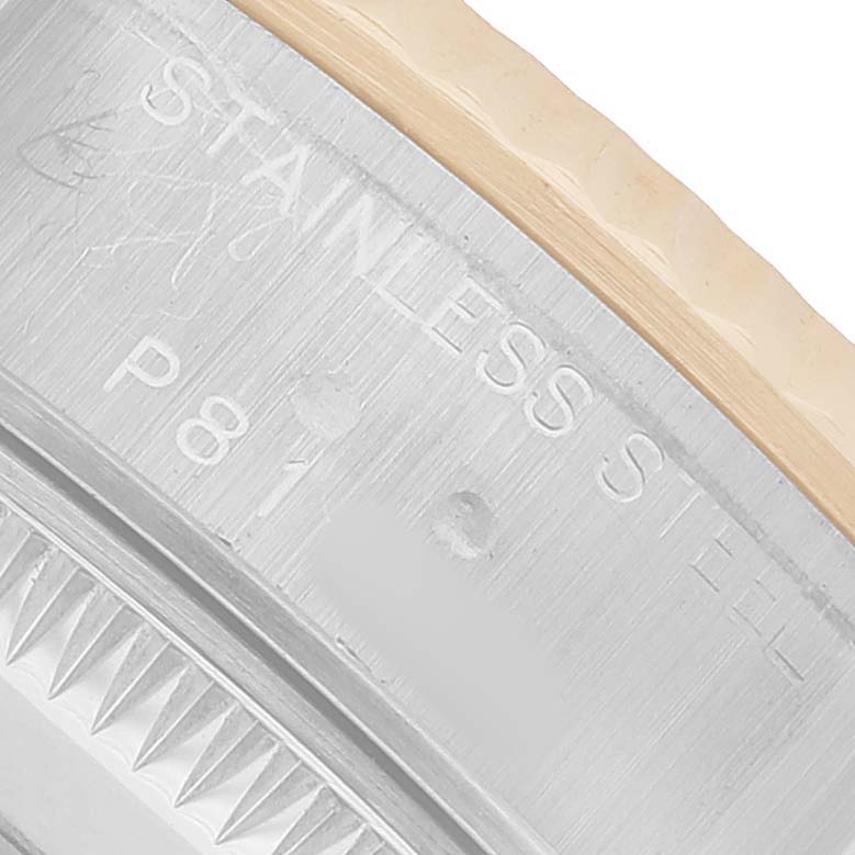 The image shows a close-up of the Rolex Datejust 79173 Women's Steel and Gold (two tone) Black Dial's case edge, highlighting the stainless steel and fluted bezel texture.