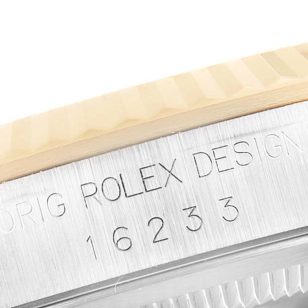This image shows a close-up of the side of a Rolex Datejust 16233 Men's Steel and Gold (two tone) Champagne Dial 16233 Men's Steel and Gold (two tone) Champagne Dial watch, featuring part of the bezel and the engraved case with the model number 16233.