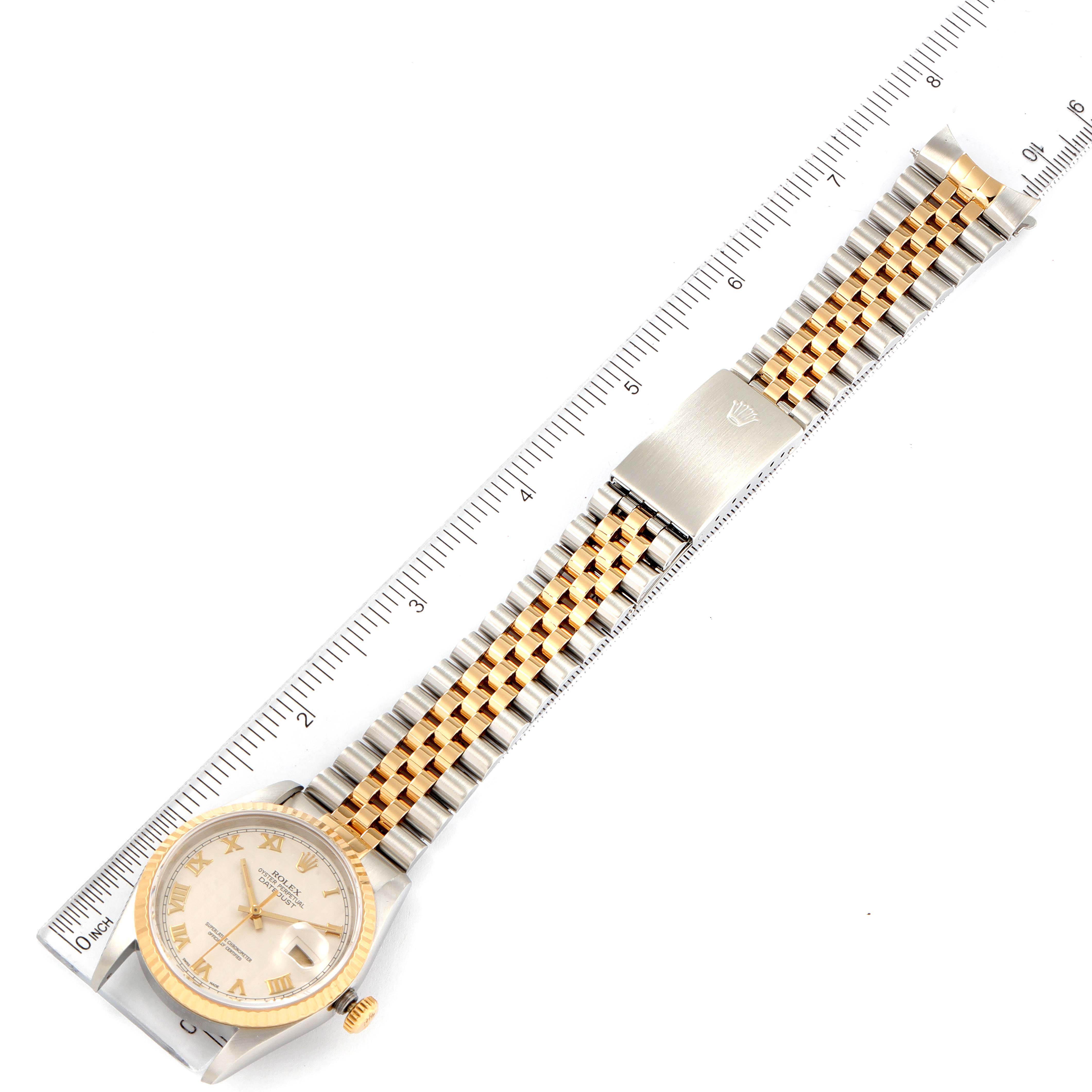 The image shows an overhead view of a Rolex Datejust 16233 Men's Steel and Gold (two tone) Beige Dial 16233 Men's Steel and Gold (two tone) Beige Dial watch with a two-tone bracelet and a ruler for scale.
