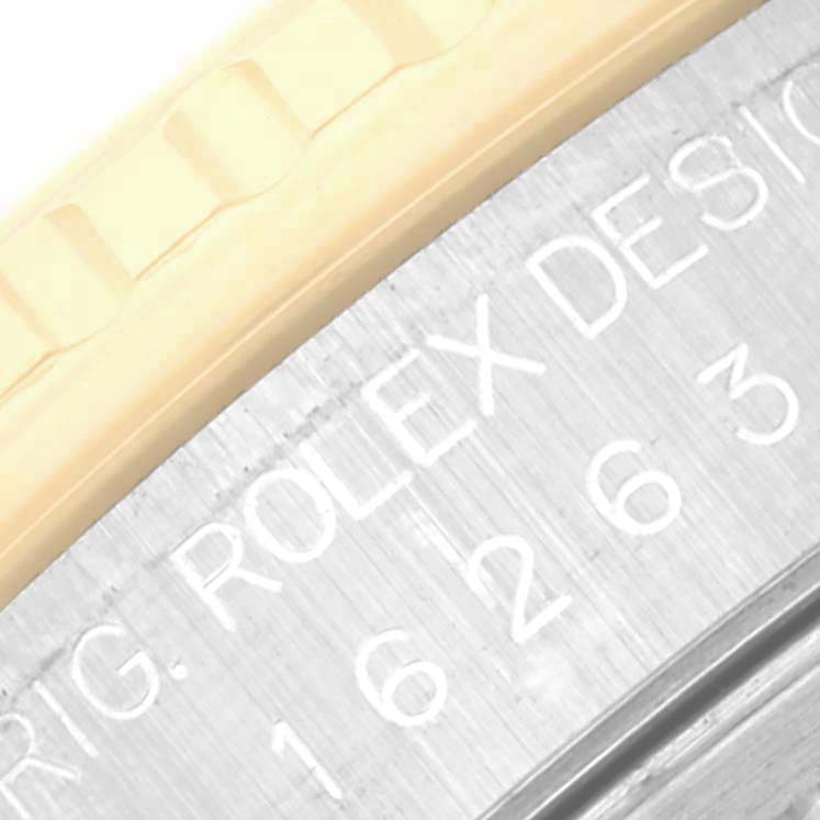 This close-up image shows the bezel and part of the engraved case back of a Rolex Turn-o-Graph 16263 Men
s Steel and Gold (two tone) Silver Dial 16263 Men
s Steel and Gold (two tone) Silver Dial watch.