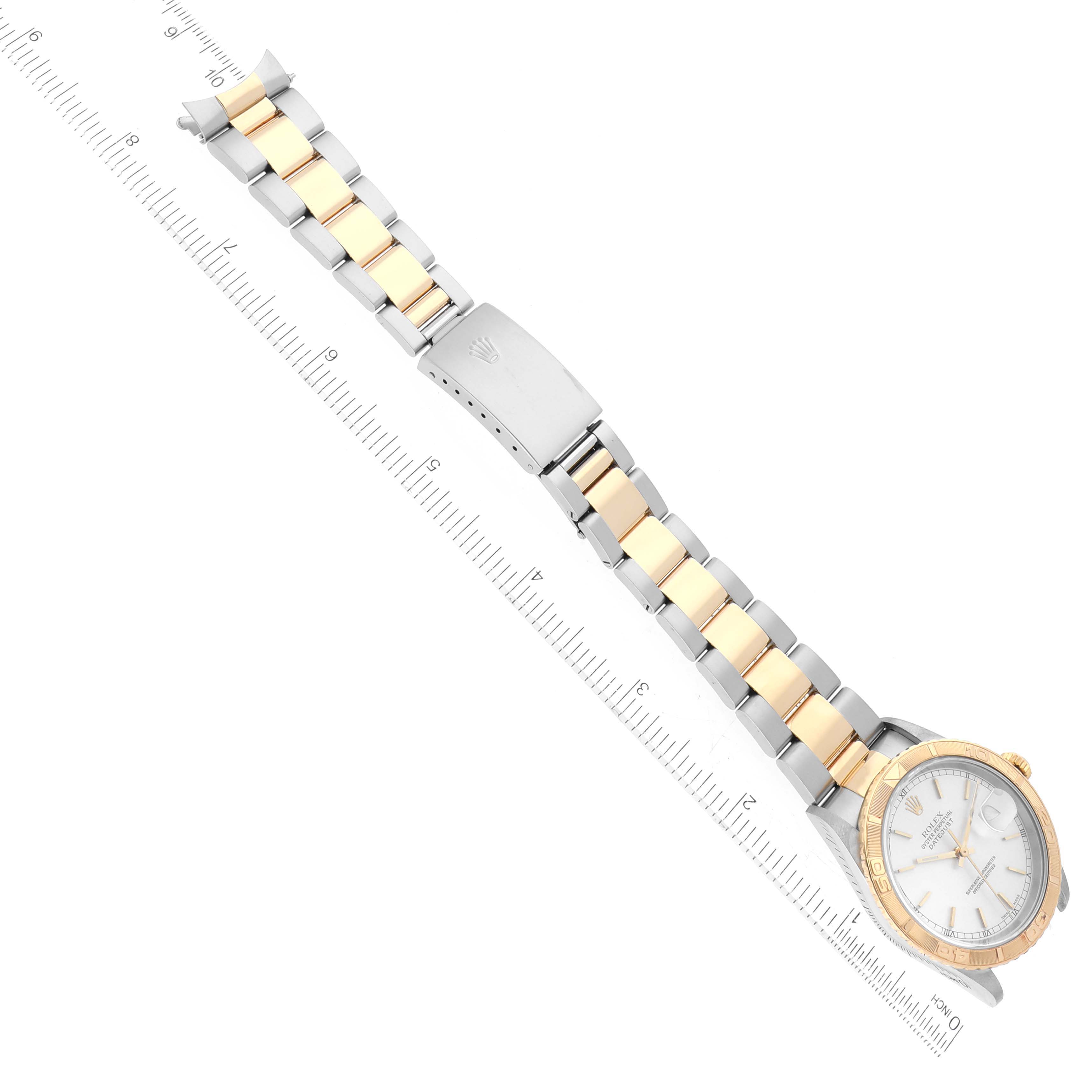 The image shows an overhead view of a Rolex Turn-o-Graph 16263 Men
s Steel and Gold (two tone) Silver Dial 16263 Men
s Steel and Gold (two tone) Silver Dial watch, highlighting its face, bezel, and two-tone bracelet with ruler measurements.