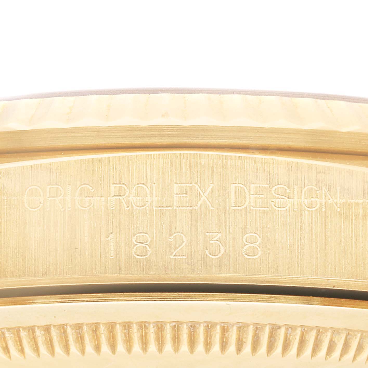 The image shows a close-up of the side of a Rolex President 18238 Men
s Yellow Gold Champagne Dial 18238 Men
s Yellow Gold Champagne Dial model watch, highlighting the engraved reference number and part of the bezel.
