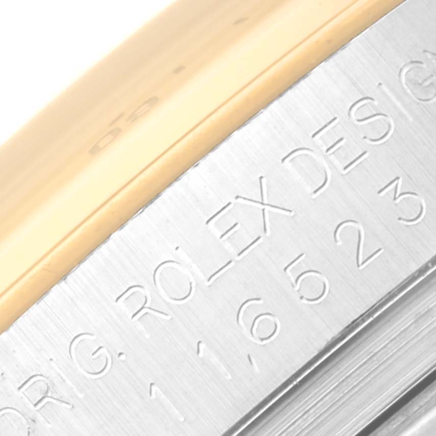 This image shows a close-up of the side engraving on the bezel and case of a Rolex Daytona 116523 Men's Steel and Gold (two tone) Mother of Pearl Dial 116523 Men's Steel and Gold (two tone) Mother of Pearl Dial watch.