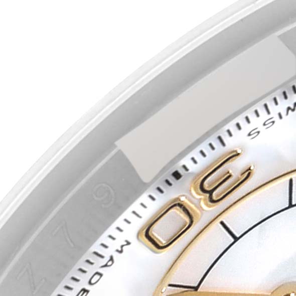 This image shows a close-up of the dial and part of the bezel of a Rolex Daytona 116523 Men's Steel and Gold (two tone) Mother of Pearl Dial 116523 Men's Steel and Gold (two tone) Mother of Pearl Dial watch.