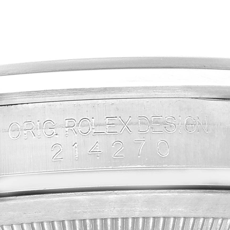 The image shows a close-up of the case side of the Rolex Explorer 214270 Men
s Stainless Steel Black Dial 214270 Men
s Stainless Steel Black Dial model, highlighting the engraving and design details.