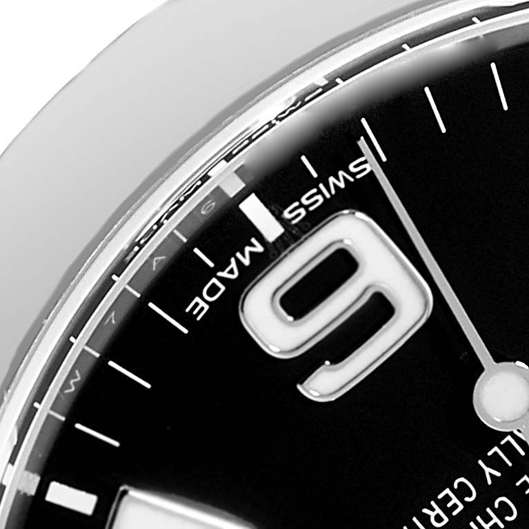 The image shows a close-up of the face of a Rolex Explorer 214270 Men
s Stainless Steel Black Dial 214270 Men
s Stainless Steel Black Dial watch, highlighting the "Swiss Made" text and the number 9.