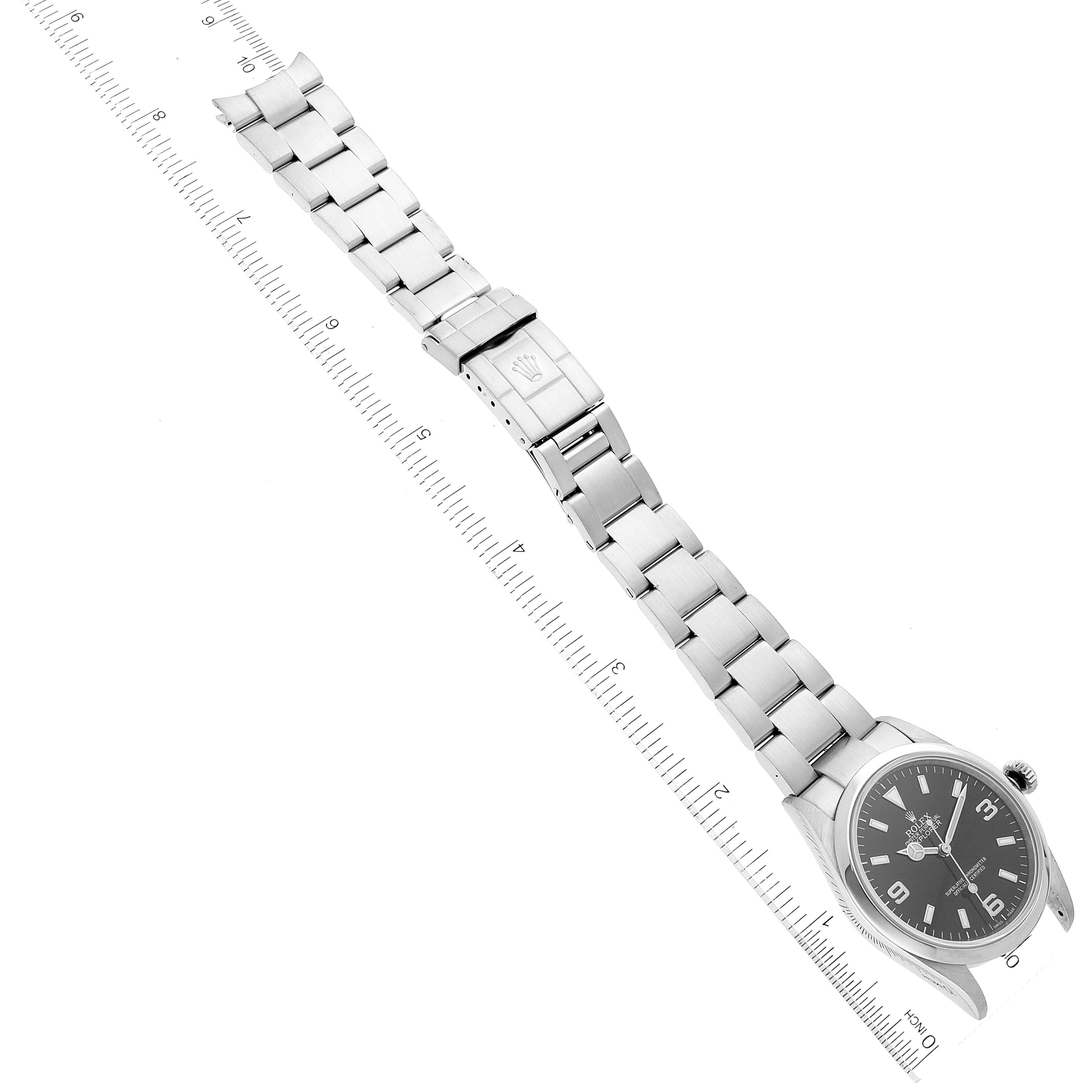 The Rolex Explorer 114270 Men's Stainless Steel Black Dial 114270 Men's Stainless Steel Black Dial watch is shown from a top-down angle, displaying the face, crown, and entire metal bracelet.