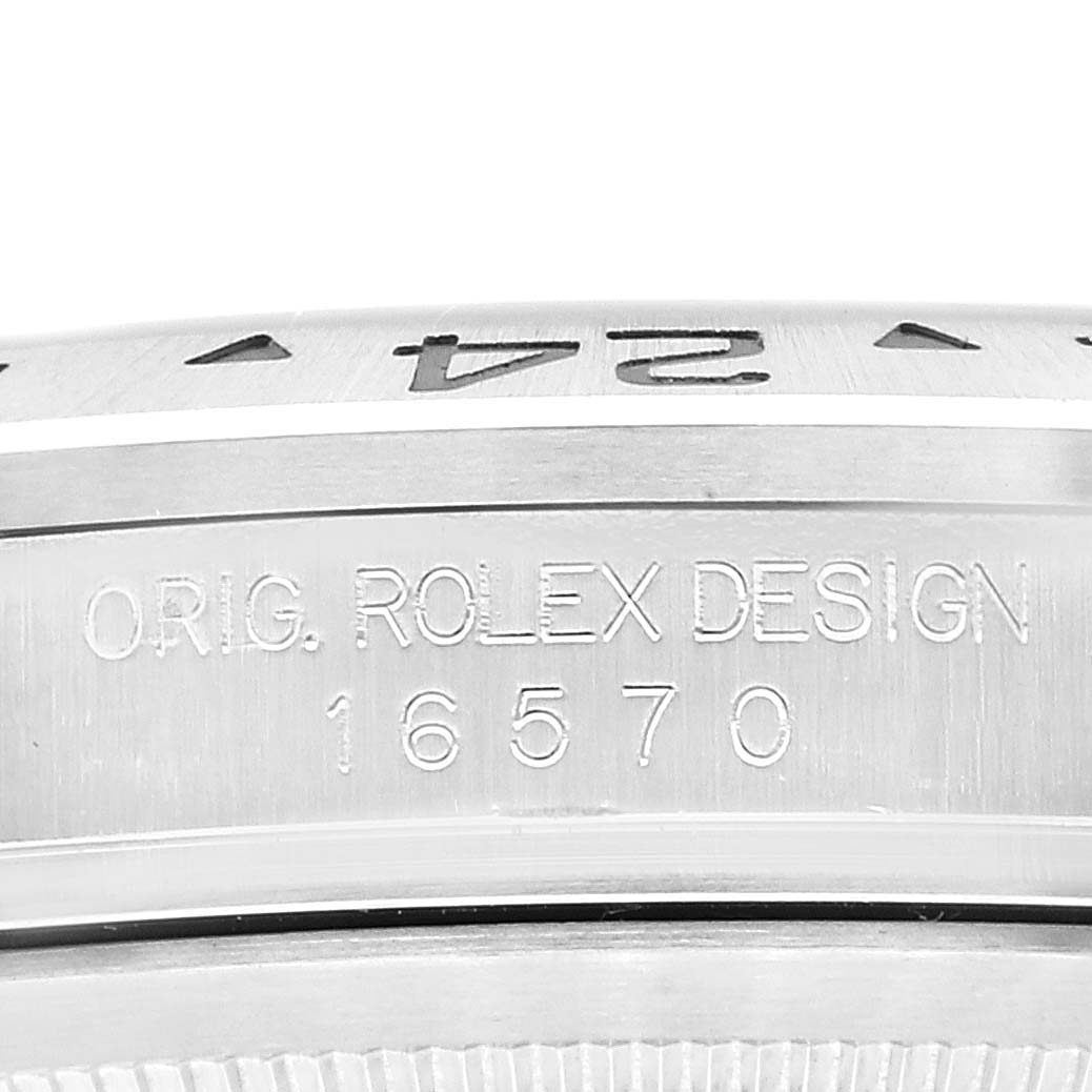 The image shows a close-up of the side of the Rolex Explorer 16570 Men
s Stainless Steel Black Dial 16570 Men
s Stainless Steel Black Dial watch model 16570, highlighting the engraved design and partial bezel.