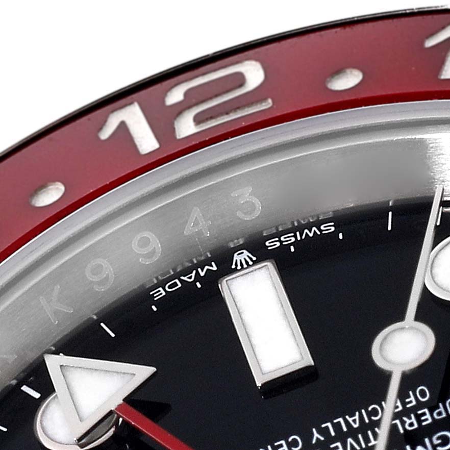 This close-up angle of the Rolex GMT-Master 126710BLRO Men
s Stainless Steel Black Dial 126710BLRO Men
s Stainless Steel Black Dial shows its red bezel, hour marker, and hands with the "Swiss Made" inscription.