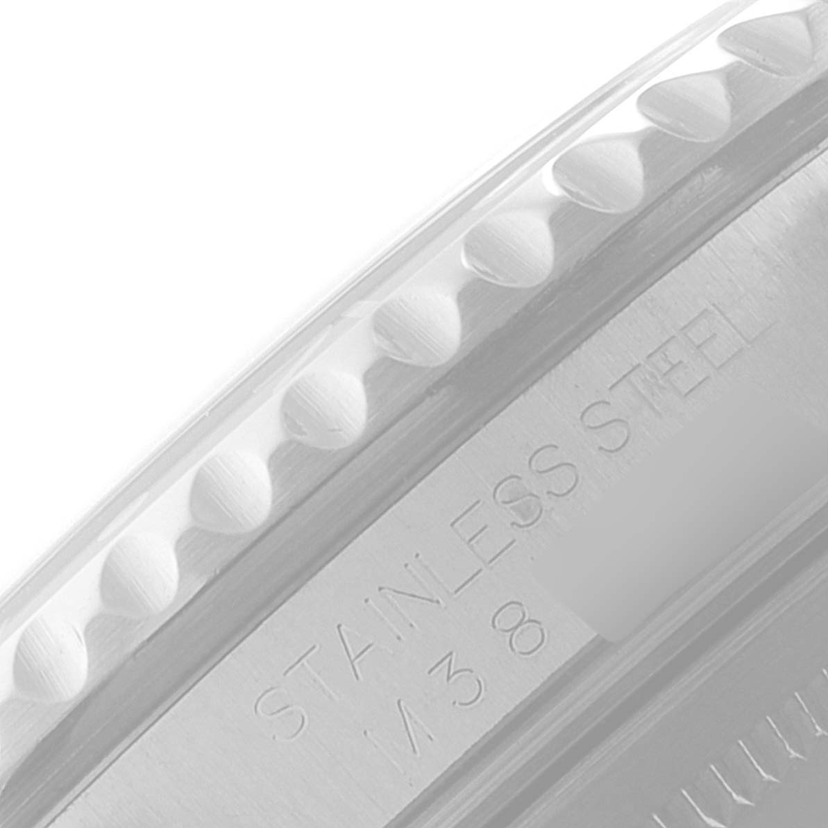 The image shows a close-up of the side of a Rolex GMT-Master 16710 Men
s Stainless Steel Black Dial 16710 Men
s Stainless Steel Black Dial watch, focusing on the edge and part of the stainless steel engraving.