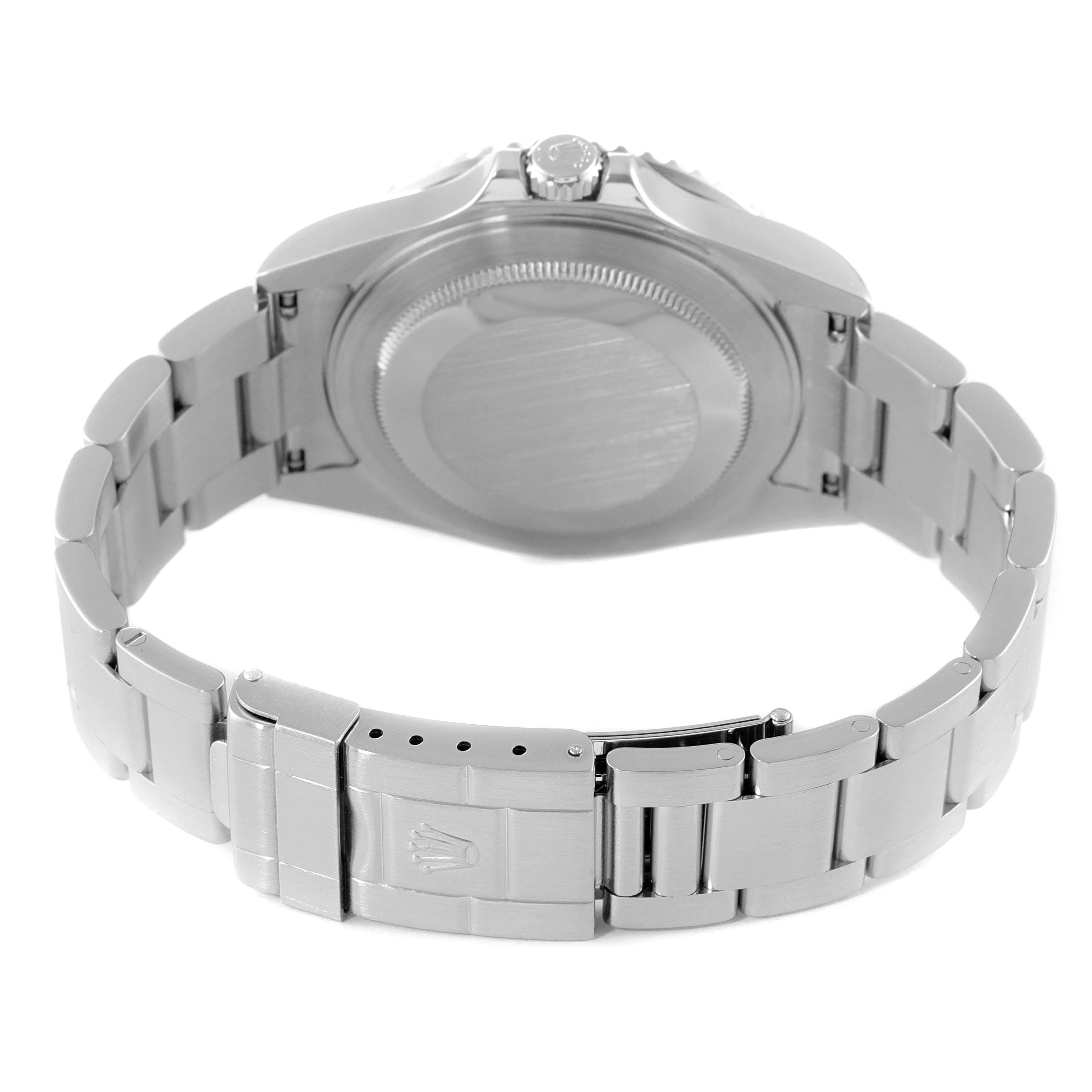 The image shows the underside of a Rolex GMT-Master 16710 Men
s Stainless Steel Black Dial 16710 Men
s Stainless Steel Black Dial watch, highlighting the case back, crown, and stainless steel bracelet clasp.