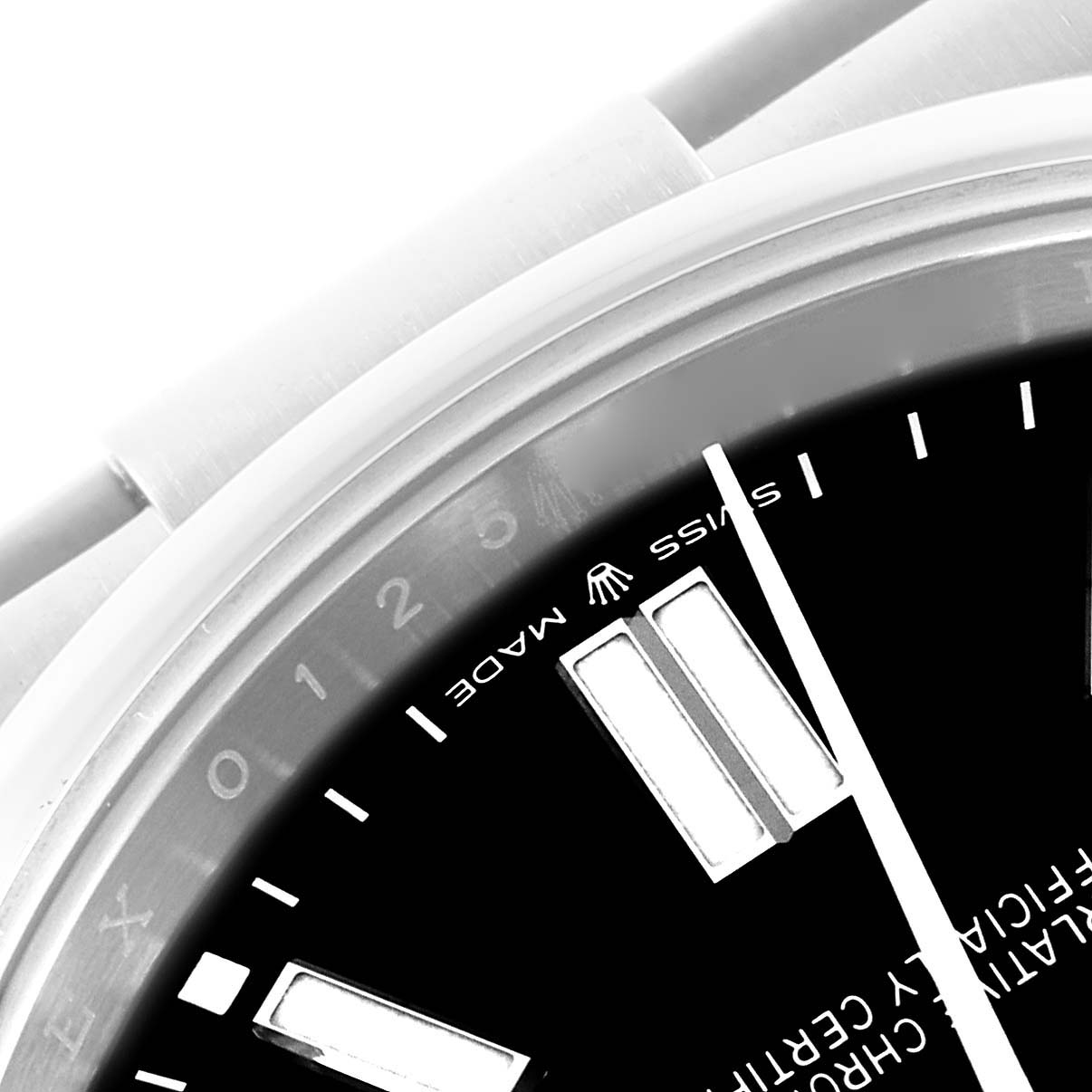 The image shows a close-up of the dial and bezel of the Rolex Oyster Perpetual 124300 Men's Stainless Steel Black Dial 124300 Men's Stainless Steel Black Dial, focusing on the Swiss Made text and markers.