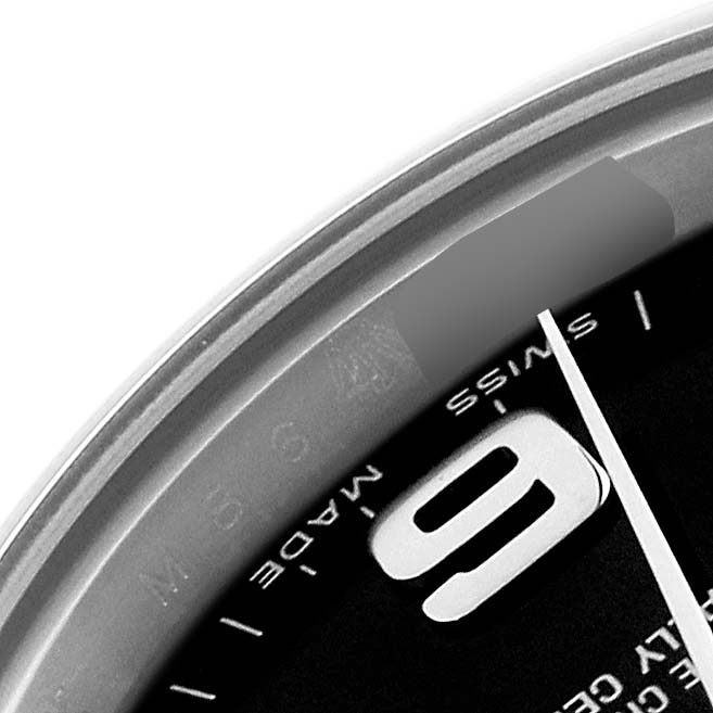 This image shows a close-up of the dial and edge of the bezel of a Rolex Oyster Perpetual 176200 Women's Stainless Steel Black Dial 176200 Women's Stainless Steel Black Dial watch, including part of the 9 o'clock marker.