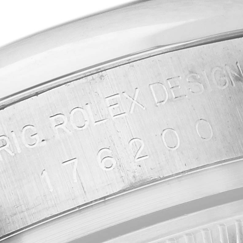 This close-up image shows the engraved side of the case of a Rolex Oyster Perpetual 176200 Women's Stainless Steel Black Dial 176200 Women's Stainless Steel Black Dial watch.