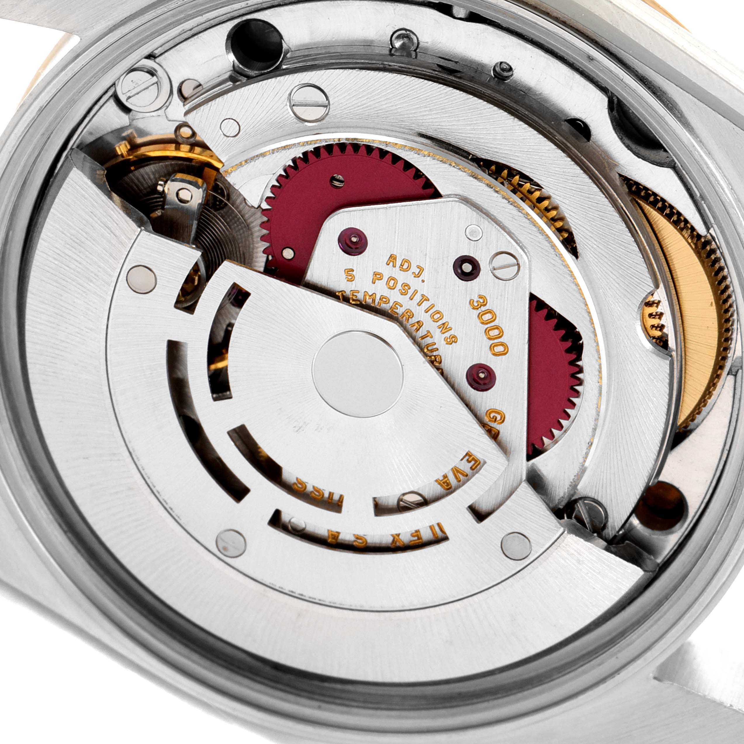 This image shows the internal mechanism of a Rolex Oyster Perpetual 14233 Men's Steel and Gold (two tone) Champagne Dial 14233 Men's Steel and Gold (two tone) Champagne Dial watch, highlighting gears and components from a close-up angle.