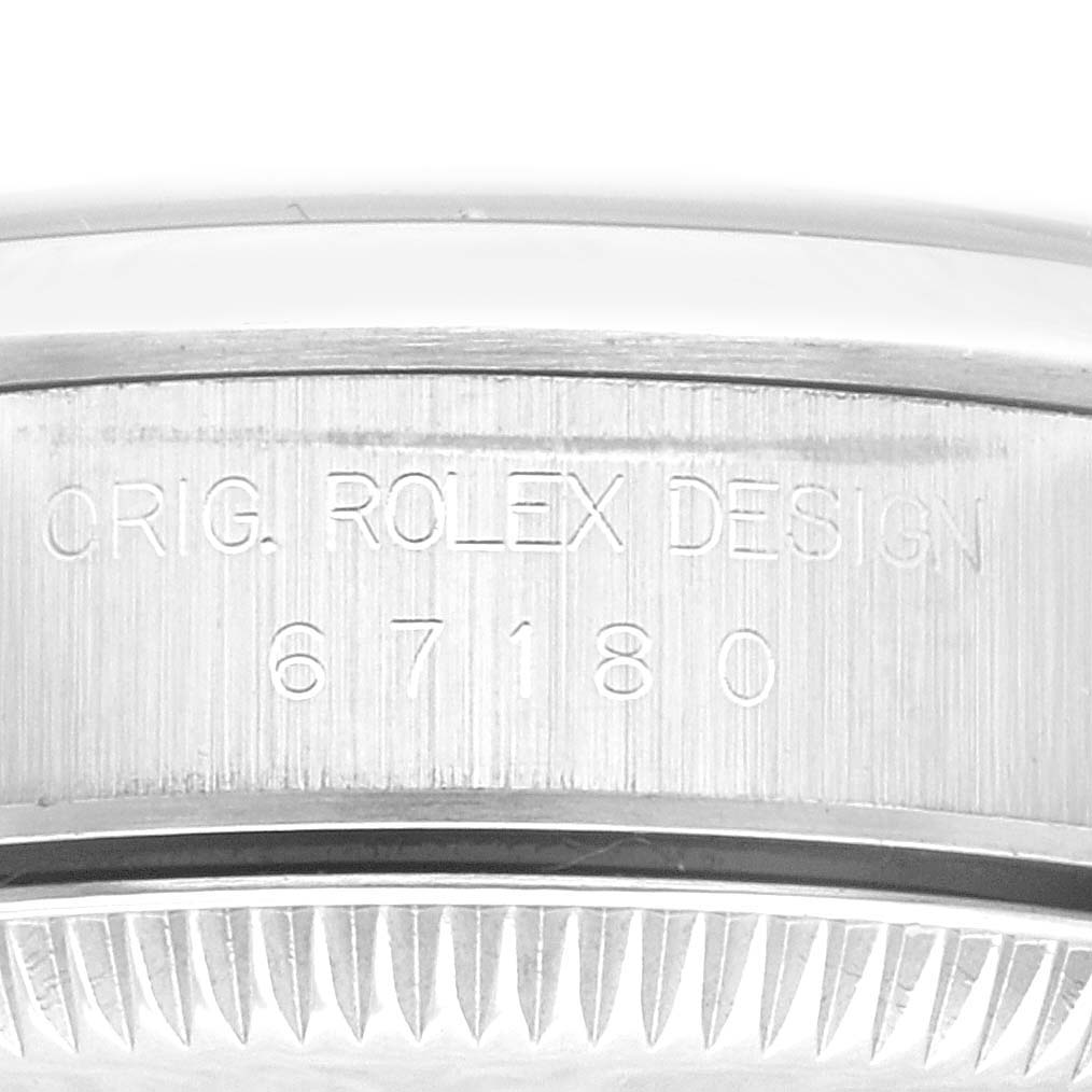 This image shows an engraving on the case back of a Rolex Oyster Perpetual 67180 Women's Stainless Steel Black Dial 67180 Women's Stainless Steel Black Dial 67180 model watch.