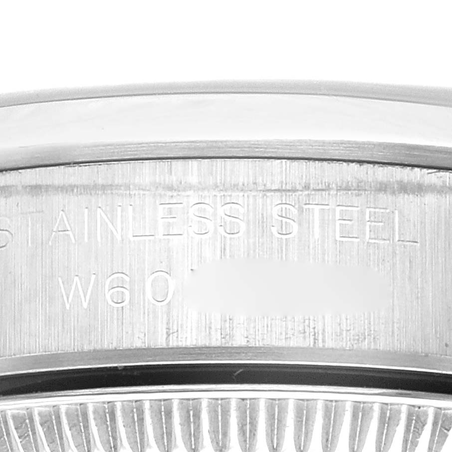 This is a close-up of the side of a Rolex Oyster Perpetual 67180 Women's Stainless Steel Black Dial 67180 Women's Stainless Steel Black Dial watch showing the serial number engraved on the stainless steel case.