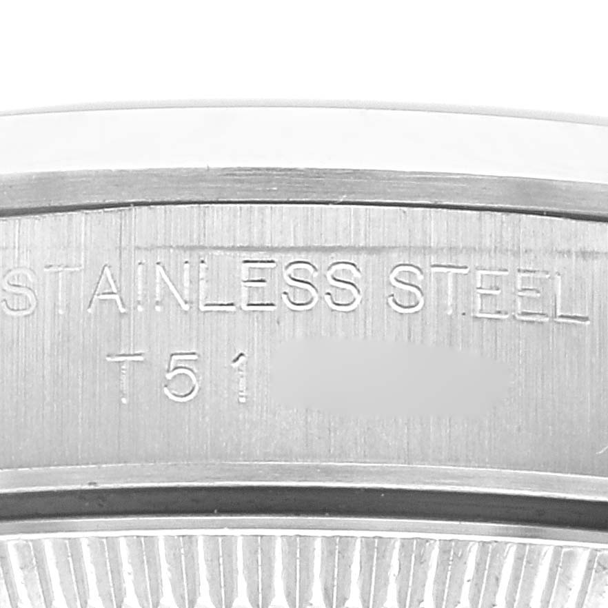 This close-up image shows the "Stainless Steel" engravings on the casing of a Rolex Oyster Perpetual 67180 Women's Stainless Steel Black Dial 67180 Women's Stainless Steel Black Dial watch.