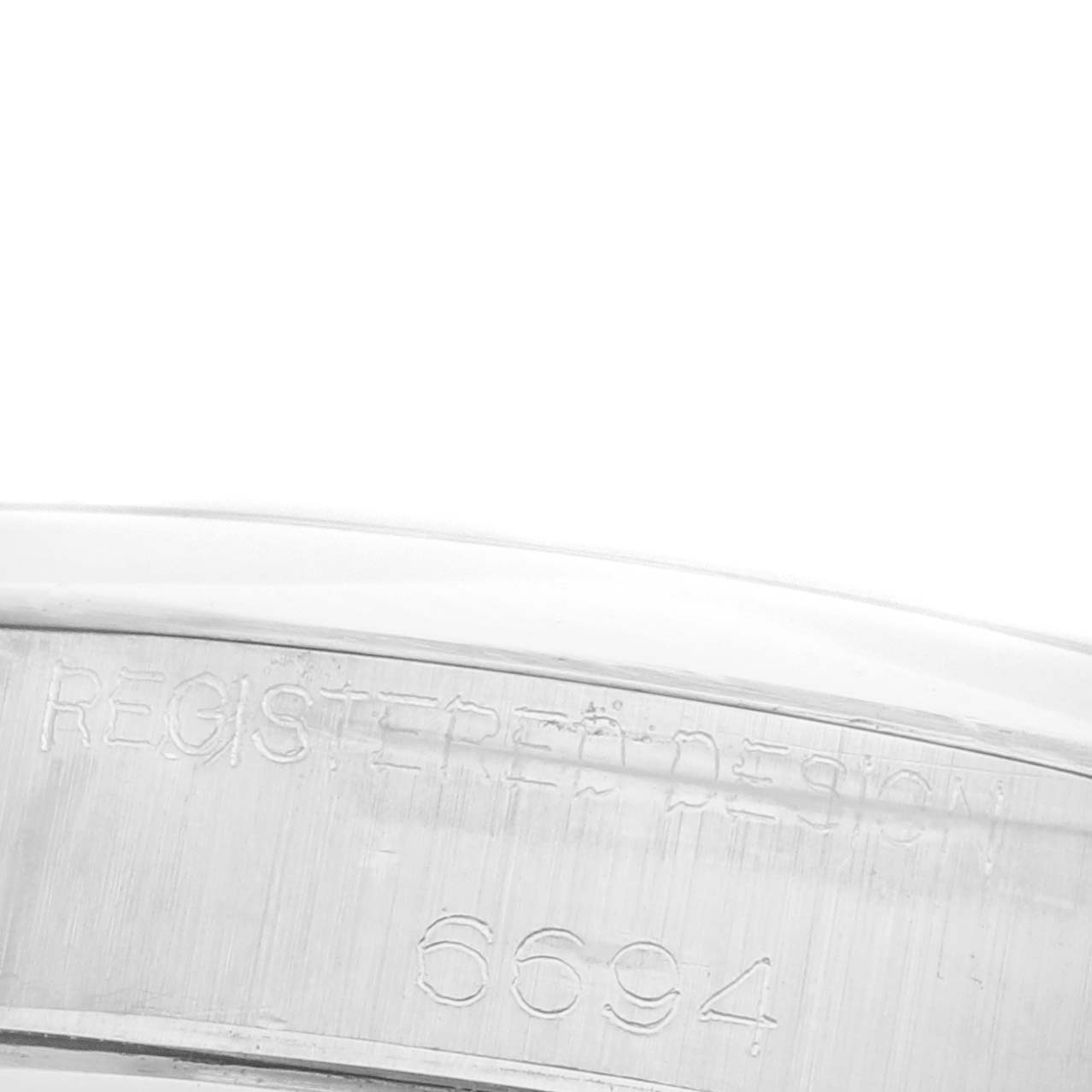 The close-up image shows the model reference number on the side of a Rolex Date 6694 Men's Stainless Steel Blue Dial 6694 Men's Stainless Steel Blue Dial watch case.