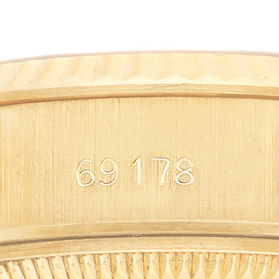 The image shows part of the case and bezel of a Rolex President 69178 Women's Yellow Gold Champagne Dial 69178 Women's Yellow Gold Champagne Dial model with its reference number engraved.