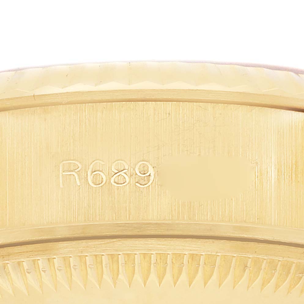 The image shows a close-up of the engraved side of a Rolex President 69178 Women's Yellow Gold Champagne Dial 69178 Women's Yellow Gold Champagne Dial watch case.