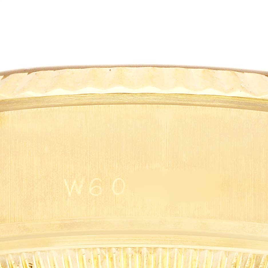 The image shows a close-up of the edge and side of a Rolex President 69178 Women's Yellow Gold Champagne Dial 69178 Women's Yellow Gold Champagne Dial model watch with visible engravings.