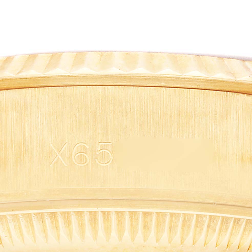 The image shows a close-up of the engraved side of a Rolex President 69178 Women's Yellow Gold Champagne Dial 69178 Women's Yellow Gold Champagne Dial model case.
