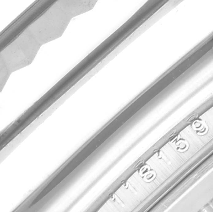 The image shows a close-up of the edge of a Rolex President 118139 Men's White Gold Blue Dial 118139 Men's White Gold Blue Dial model, highlighting the fluted bezel and part of the chapter ring.