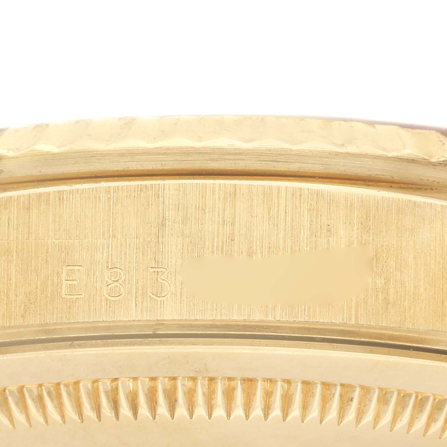 The image shows a side view of the Rolex President 18238 Men's Yellow Gold Champagne Dial 18238 Men's Yellow Gold Champagne Dial model, focusing on the case with engravings.