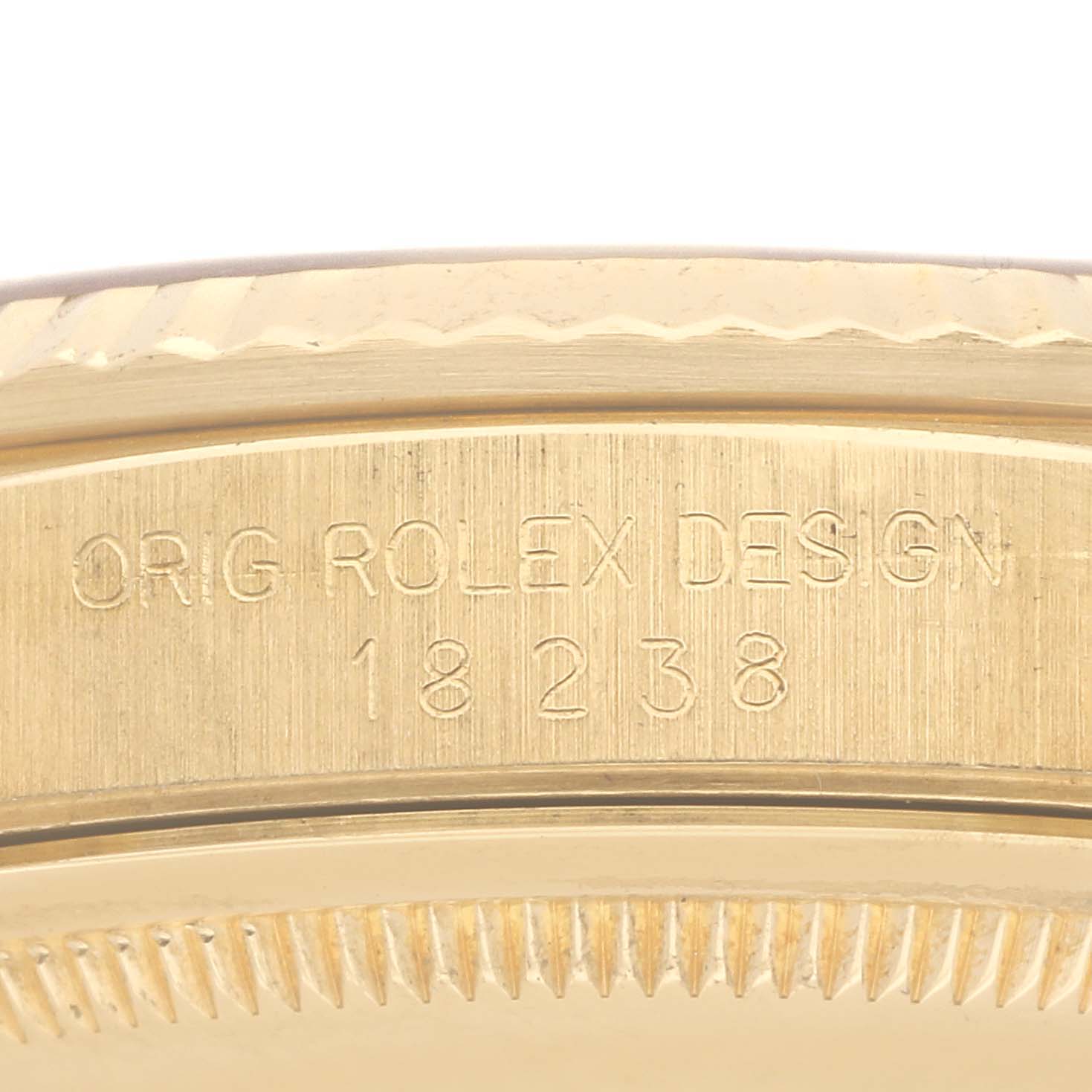The image shows the side of a Rolex President 18238 Men's Yellow Gold Champagne Dial 18238 Men's Yellow Gold Champagne Dial model, highlighting the engraved case design and model number.