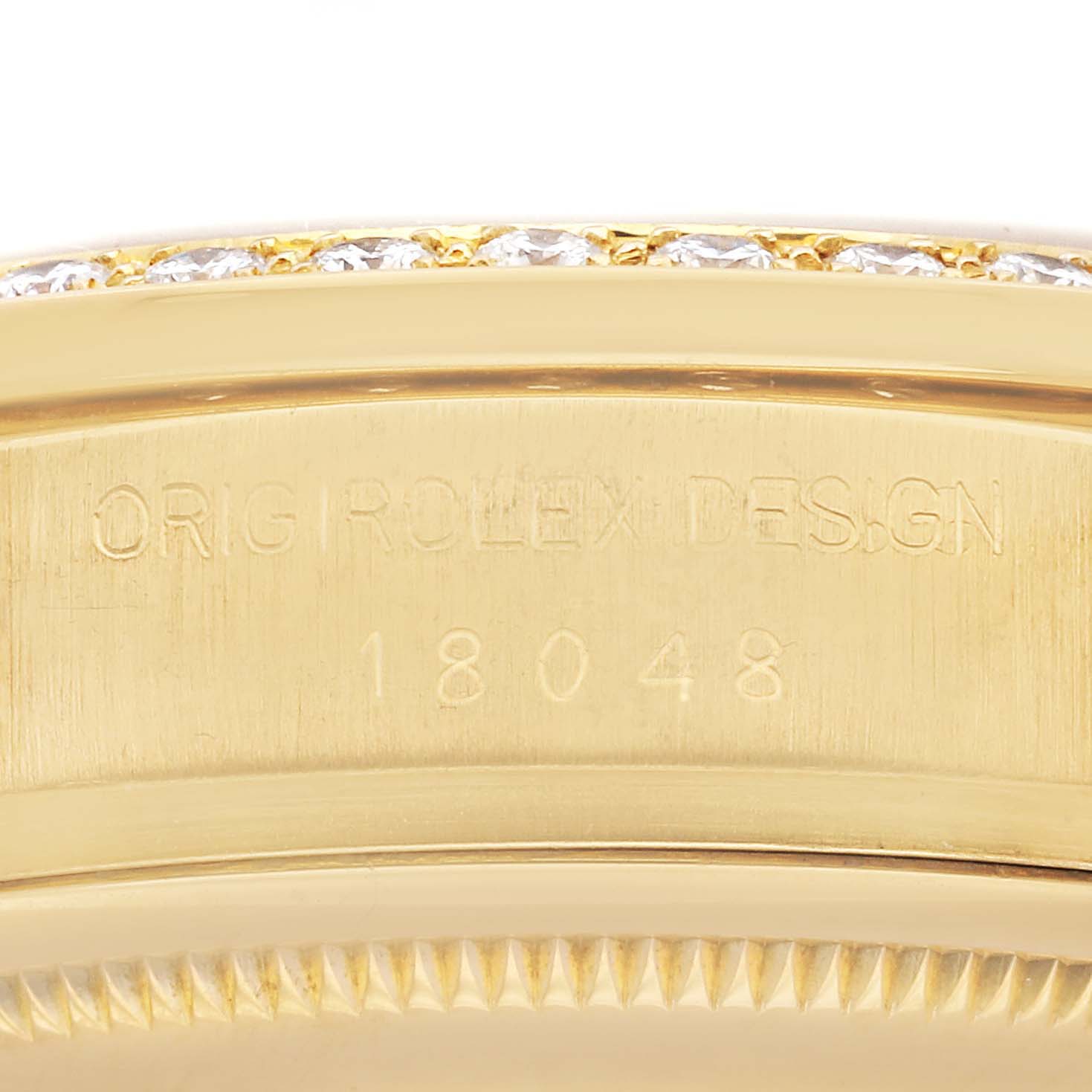 The image shows the side of a Rolex President 18048 Men's Yellow Gold Champagne Dial 18048 Men's Yellow Gold Champagne Dial model watch, focusing on the case with visible engravings.