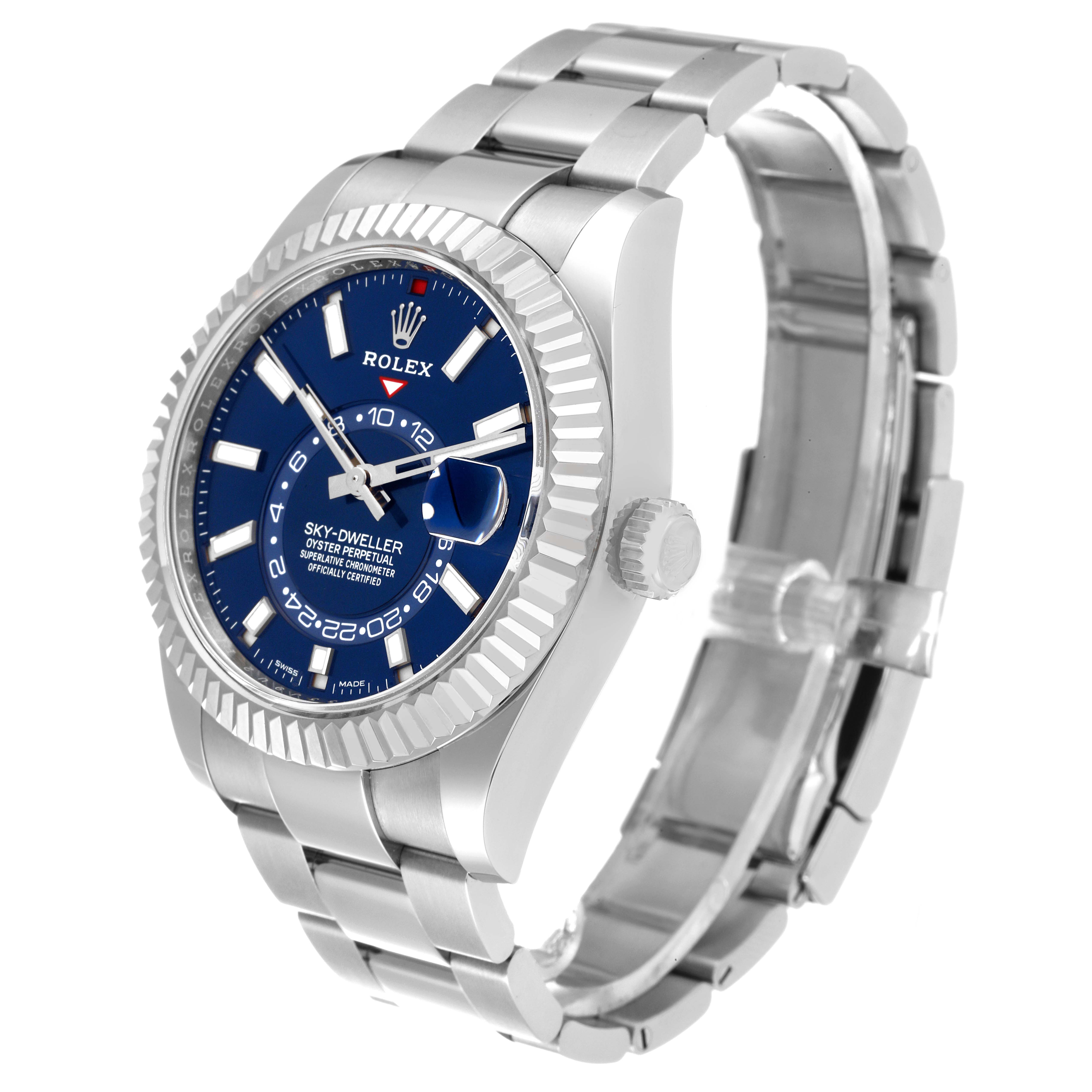 The Rolex Sky-Dweller 326934 Men's Stainless Steel Blue Dial 326934 Men's Stainless Steel Blue Dial watch is shown at an angled side view, displaying the face, bezel, crown, and metal bracelet.