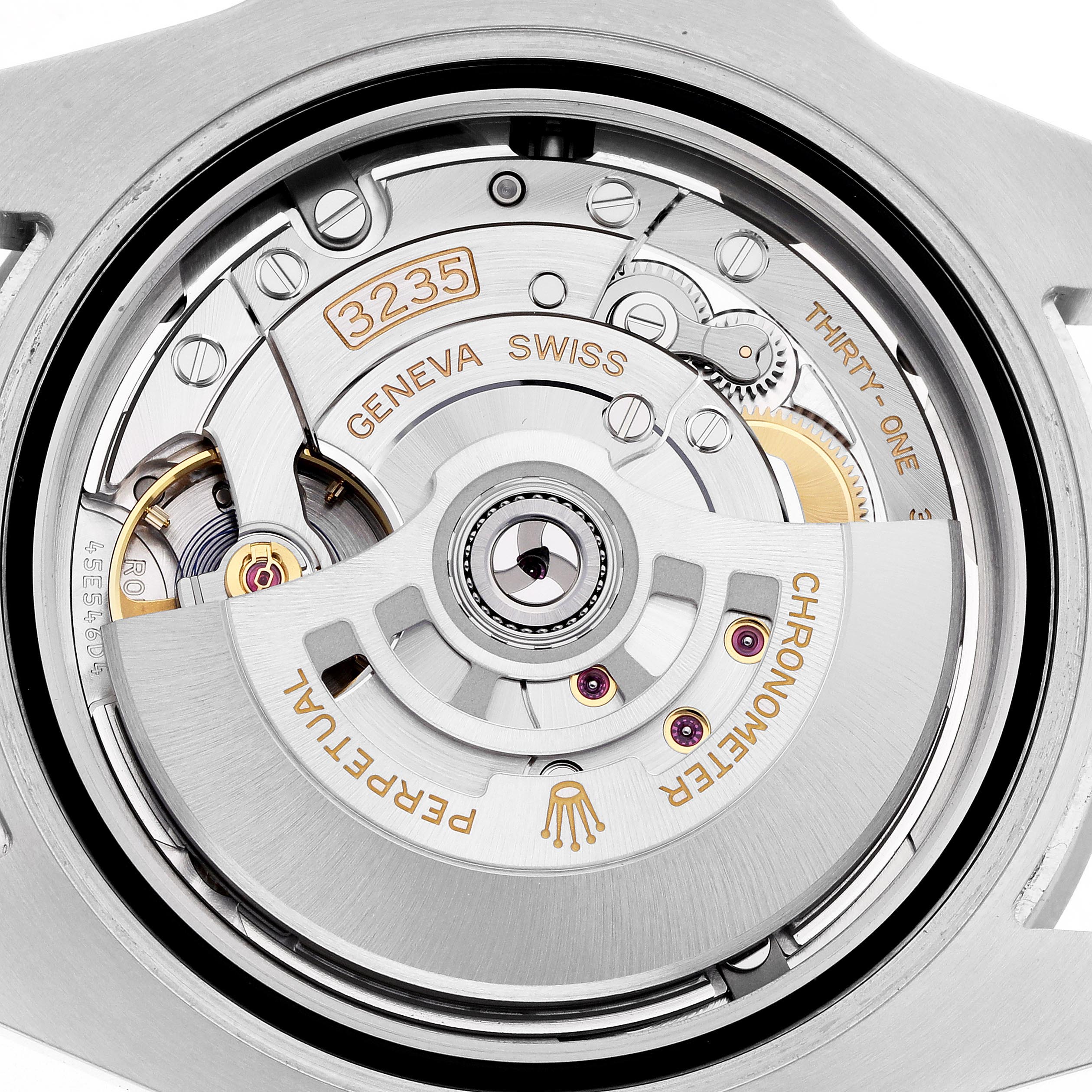 The image shows the movement of a Rolex Submariner 126610LN Men's Stainless Steel Black Dial 126610LN Men's Stainless Steel Black Dial's watch, highlighting its intricate gears and rotor.