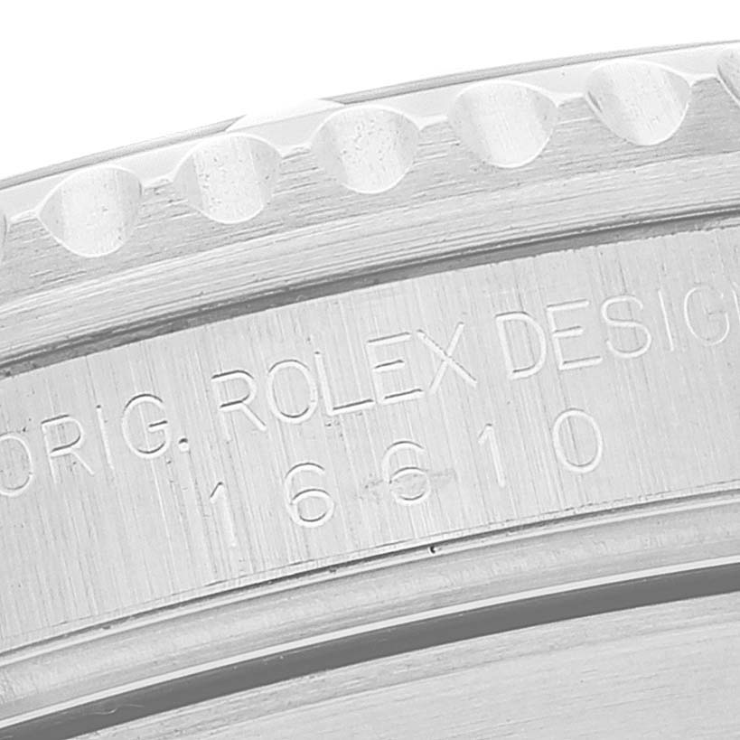 This image shows a close-up of the engraved serial number on the outer edge of the bezel of a Rolex Submariner 16610 Men
s Stainless Steel Black Dial 16610 Men
s Stainless Steel Black Dial watch.