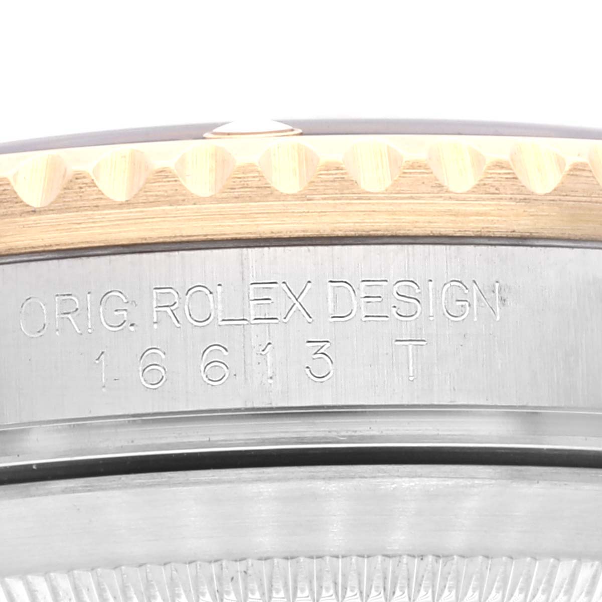 The image shows the side profile of a Rolex Submariner 16613 Men's Steel and Gold (two tone) Black Dial, focusing on the engraved model number and design text on the case side.