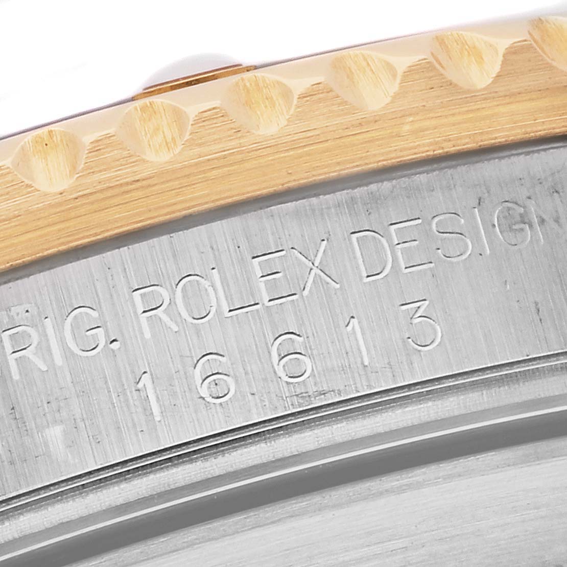 The image shows a close-up of the side of a Rolex Submariner 16613LB Men's Steel and Gold (two tone) Champagne Dial 16613LB Men's Steel and Gold (two tone) Champagne Dial, highlighting its model number and bezel.