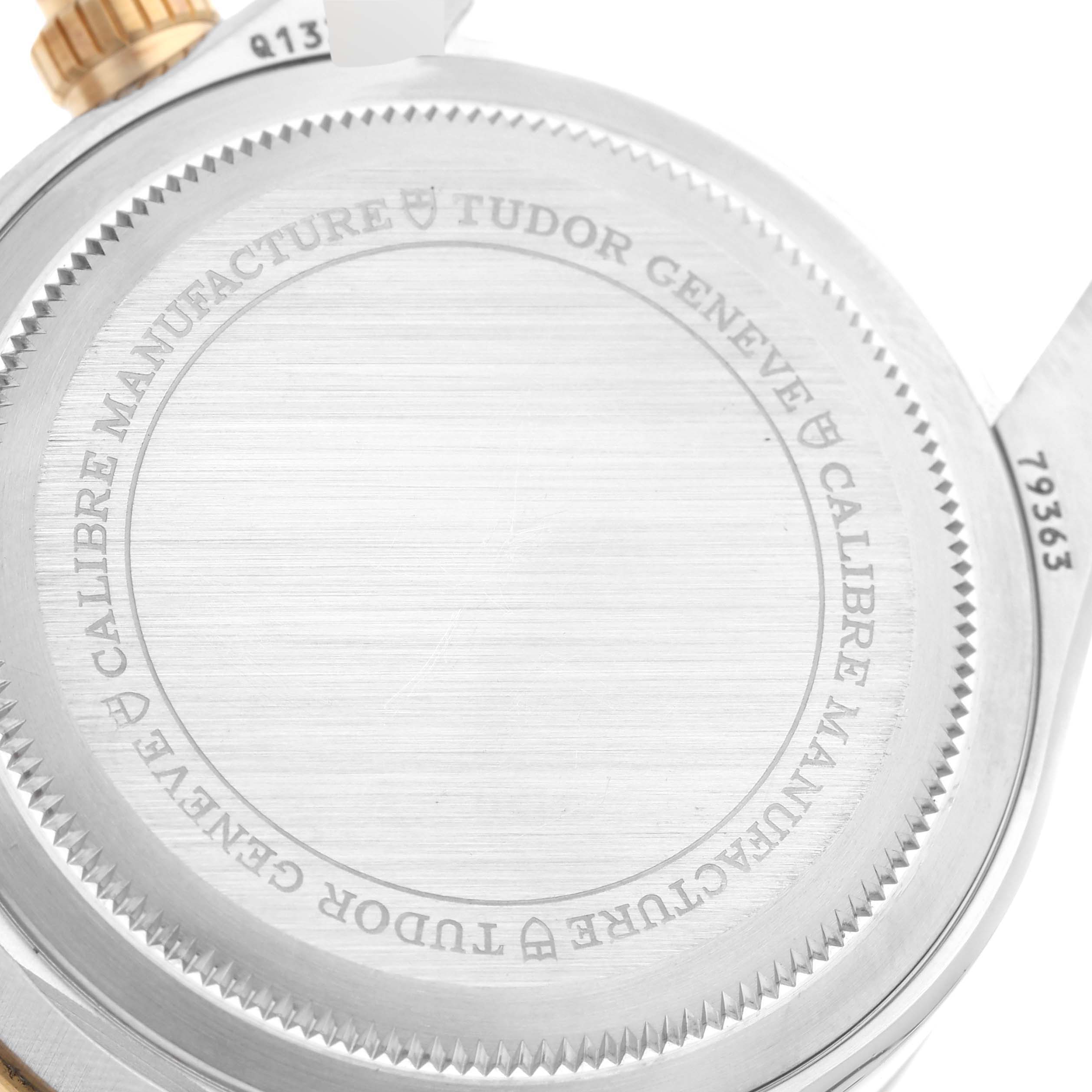 The image shows the case back and part of the case of a Tudor Heritage Black Bay 79363N Men's Steel and Gold (two tone) Black Dial 79363N Men's Steel and Gold (two tone) Black Dial watch.