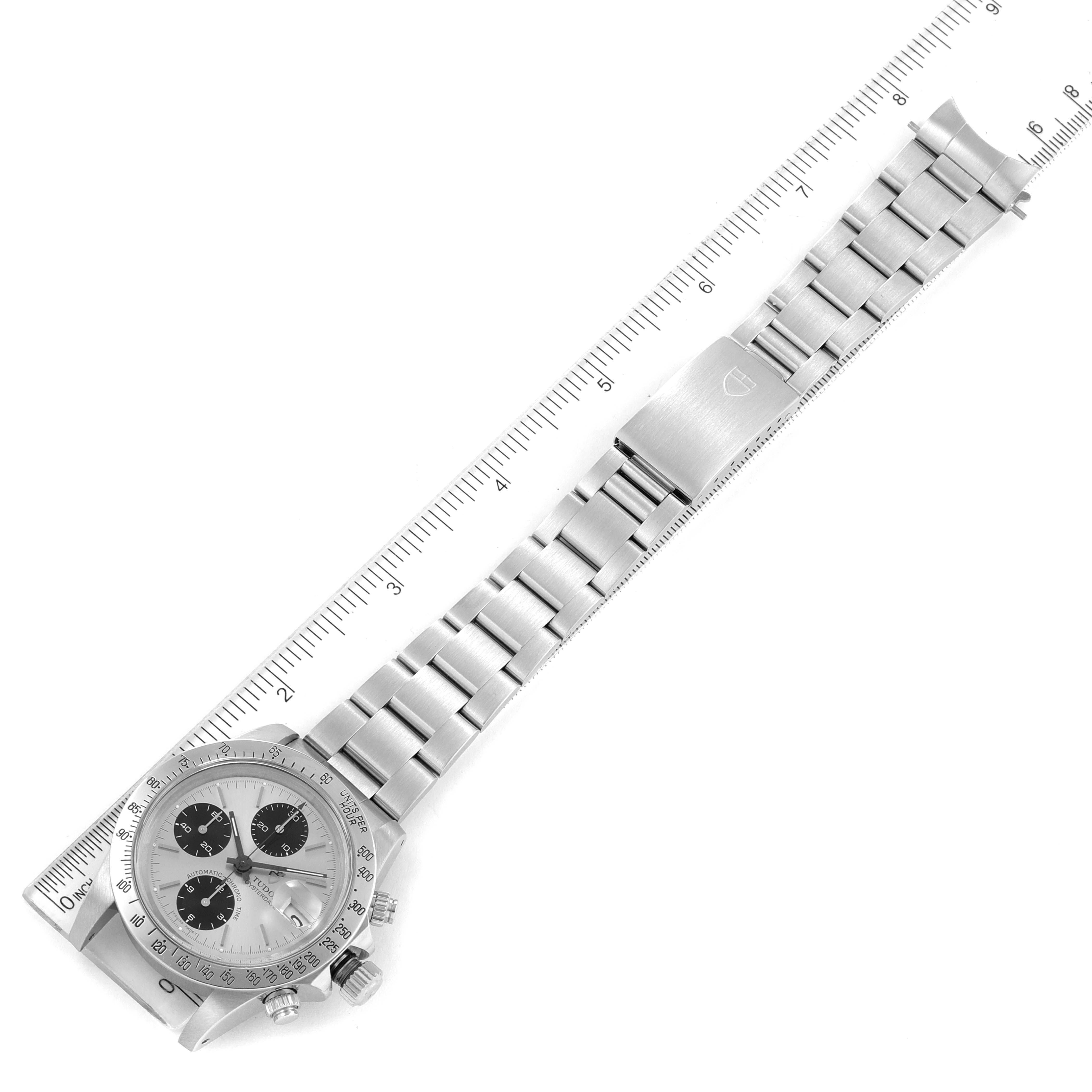 The Tudor Prince 79180 Men's Stainless Steel Silver Dial 79180 Men's Stainless Steel Silver Dial watch is shown from an overhead angle, highlighting its face and full metal bracelet with a clasp on a ruler.