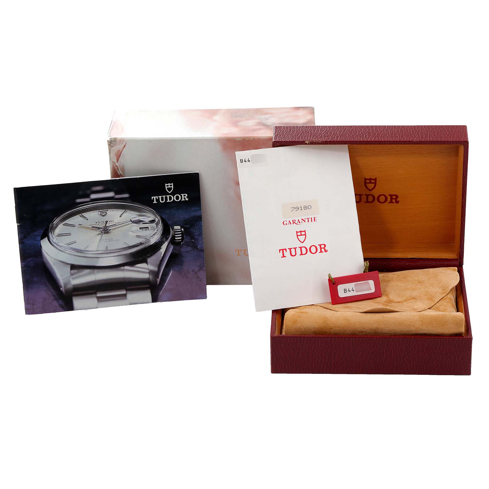 The image shows accessories for the Tudor Prince 79180 Men's Stainless Steel Silver Dial 79180 Men's Stainless Steel Silver Dial model, including the box, warranty card, and manual.