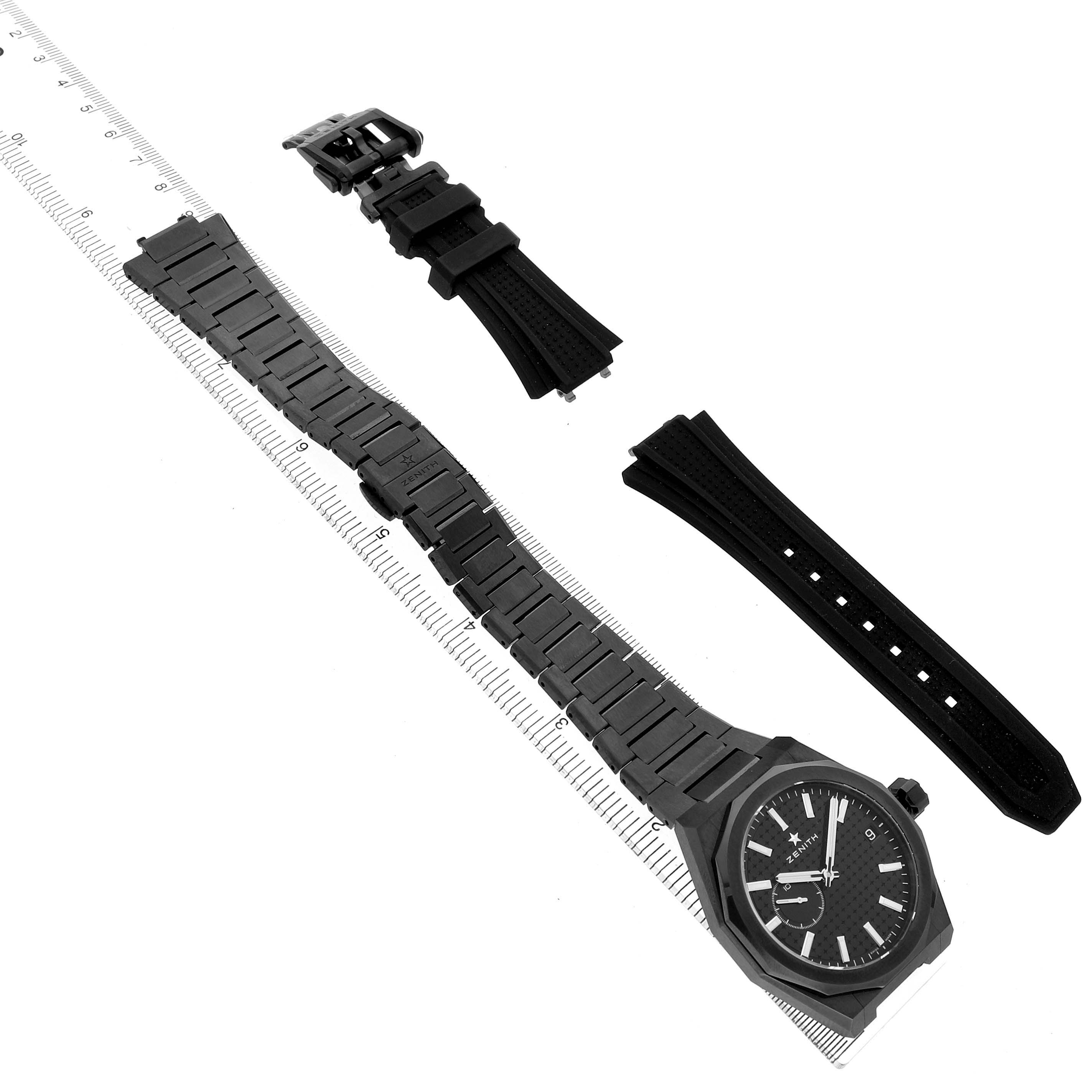 The image shows a Zenith Defy Skyline Black Ceramic Black Dial watch with a full bracelet and additional straps, viewed from above.