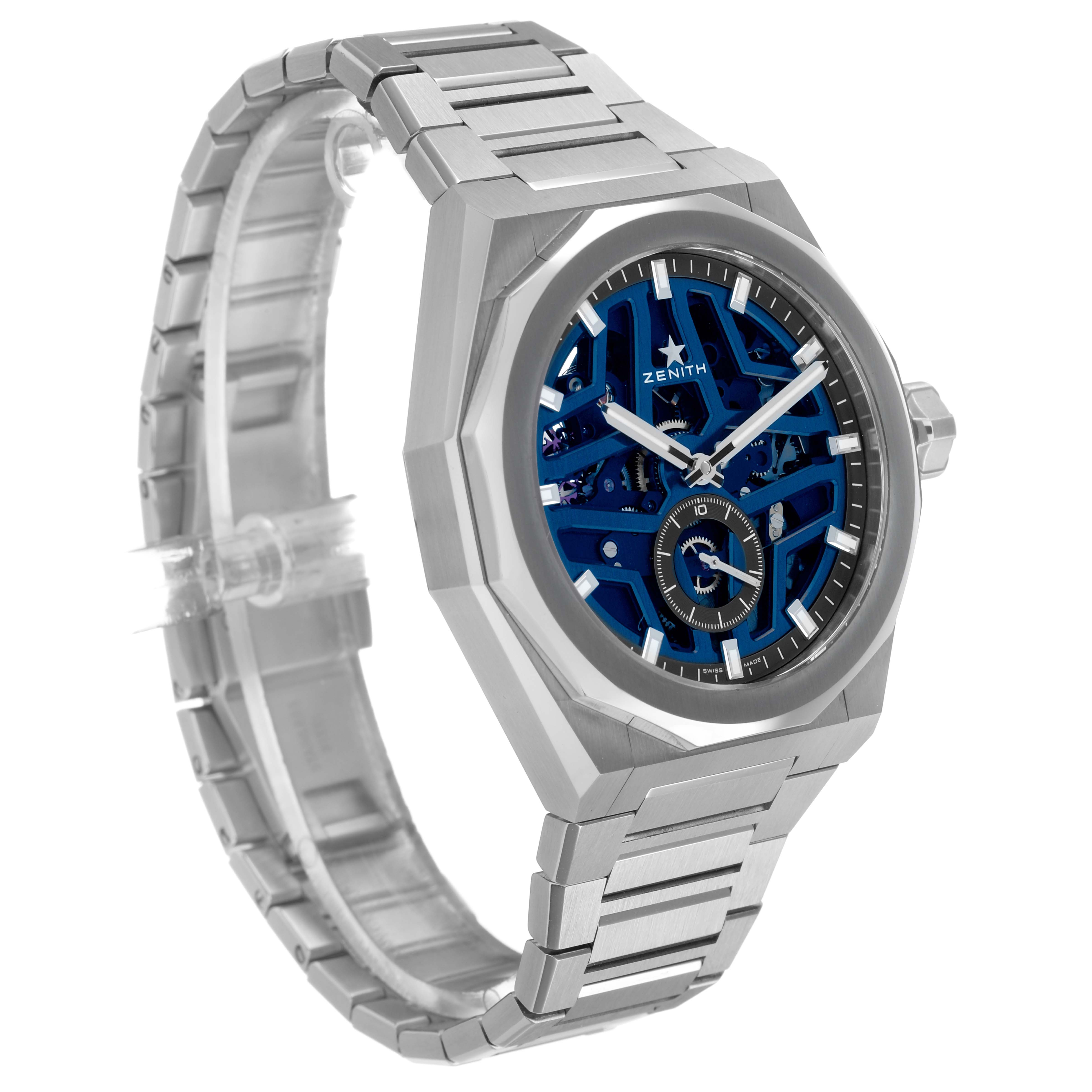 The Zenith Defy 03.9300.3620 / 79.I001 Men's Stainless Steel Blue Dial watch is shown at a three-quarter angle, highlighting its stainless steel case, skeleton dial, and metal bracelet.